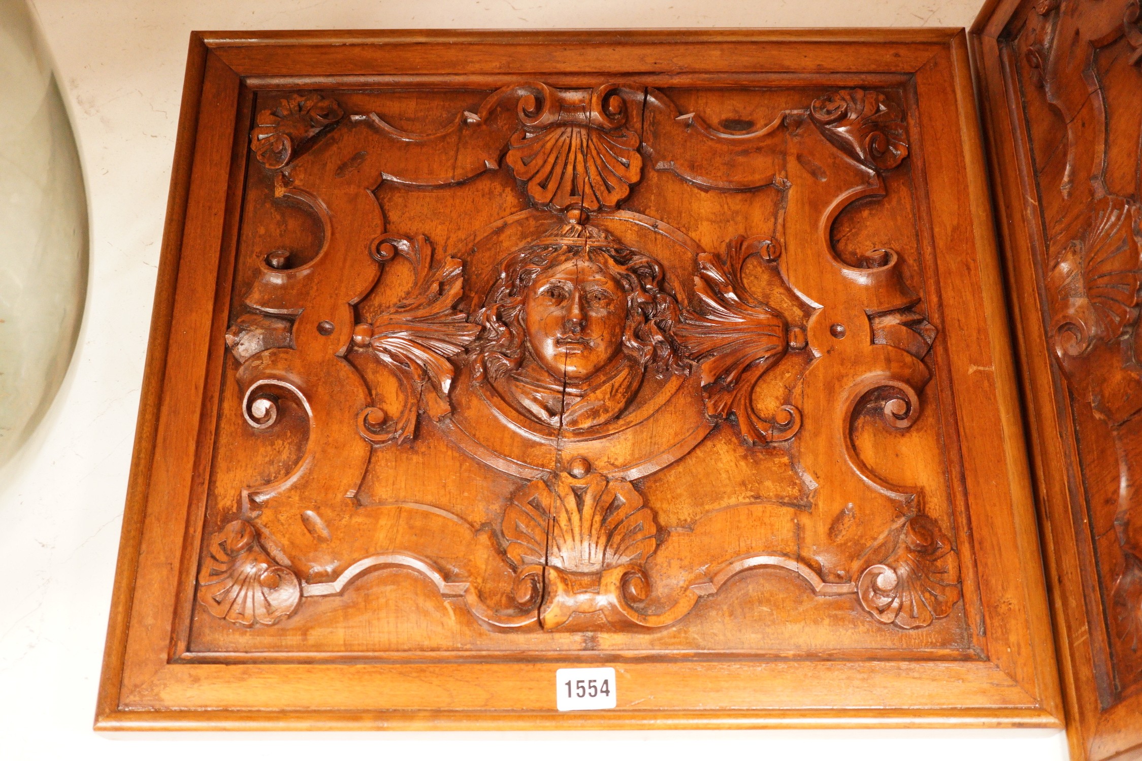 A pair of Mannerist style carved walnut panels, 47x52cm